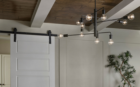 A room with white cabinets and a chandelier.
