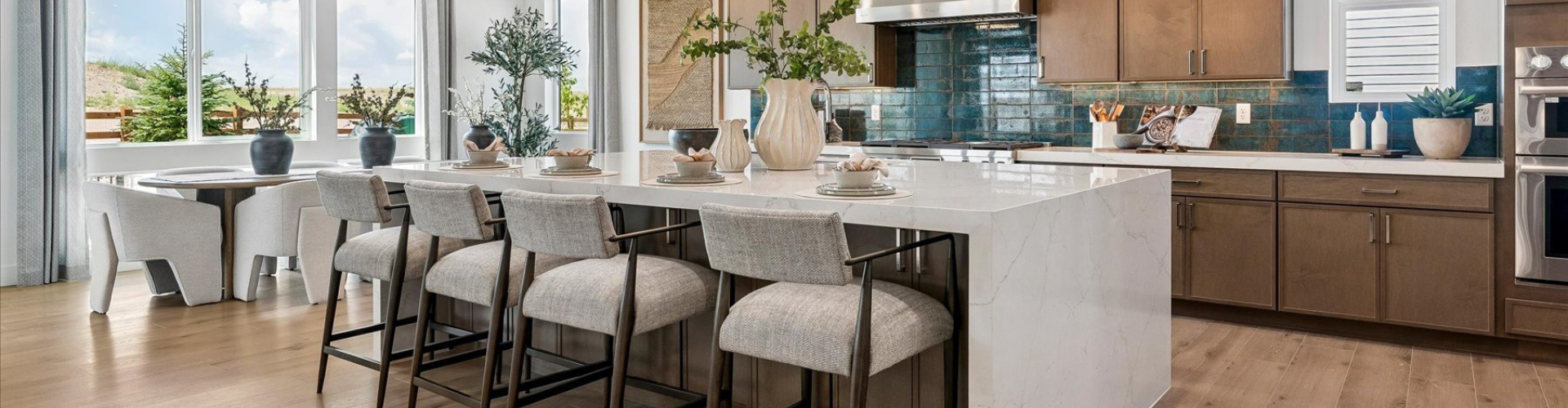 A kitchen with a table and chairs.