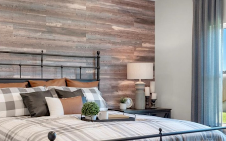 A bedroom with a large window.