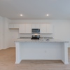Image of the Gannett plan kitchen, dining and kitchen at 4422 Chandler Road, building #30 at Covington in San Antonio by Century Communities