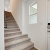 Staircase at entry in Whitney plan at 4422 Chandler Road, building #31 at Covington in San Antonio by Century Communities