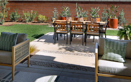 A patio with chairs and a table.