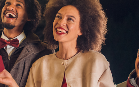 A group of people holding boxes.