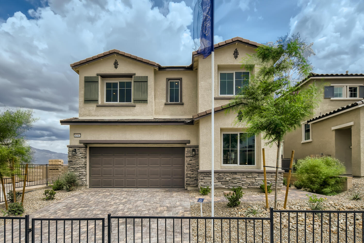 A house with a fence in front.