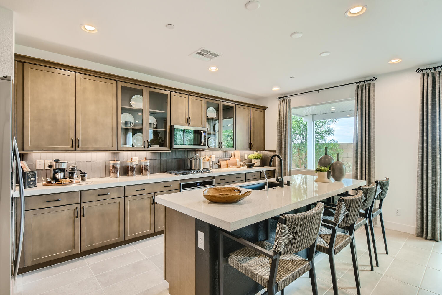 A kitchen with a table and chairs.
