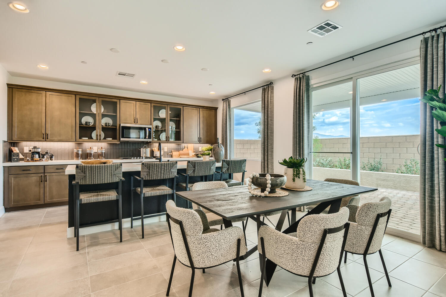 A kitchen with a dining table and chairs.