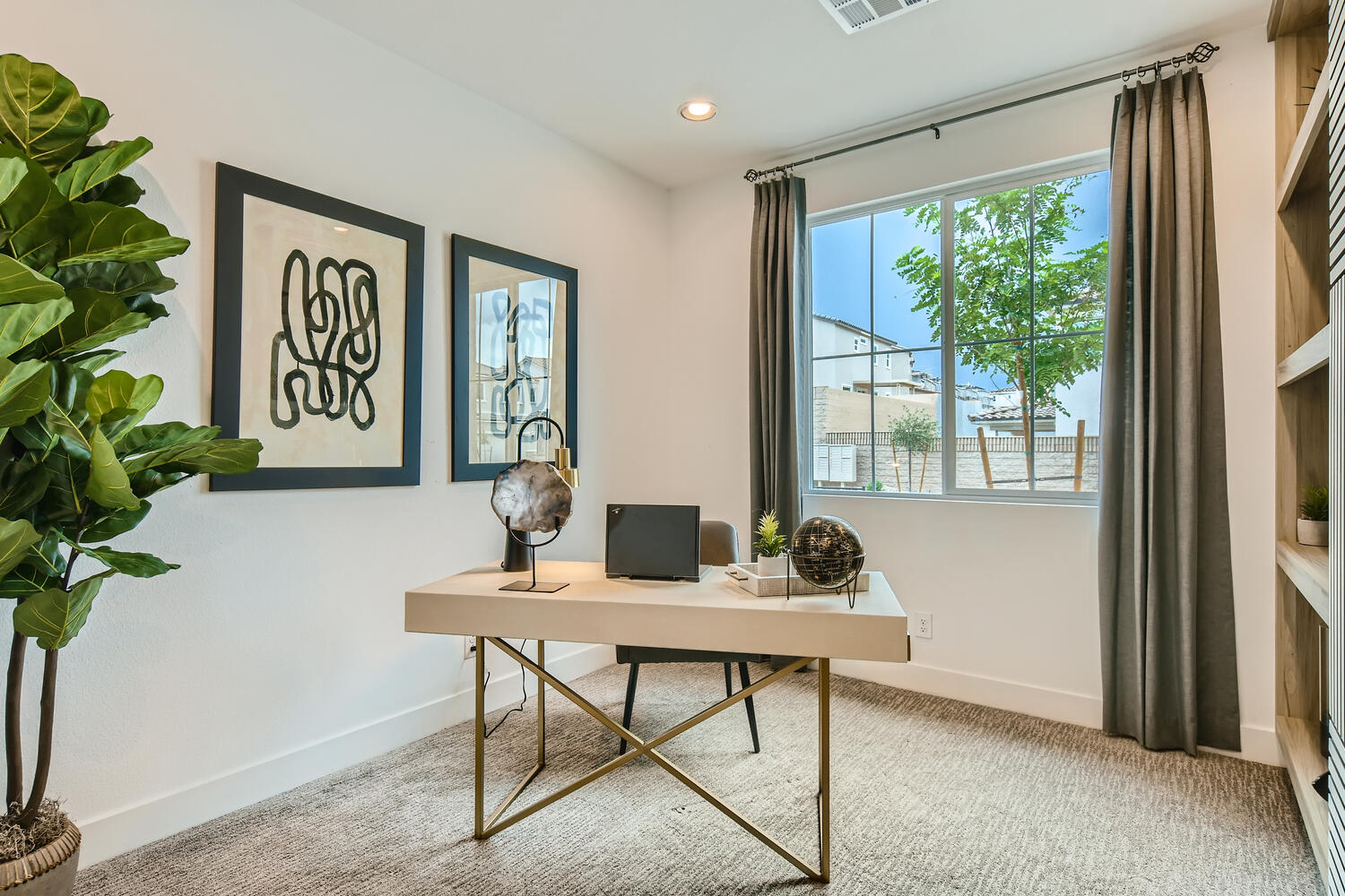 A room with a table and a window with a plant and a plant.