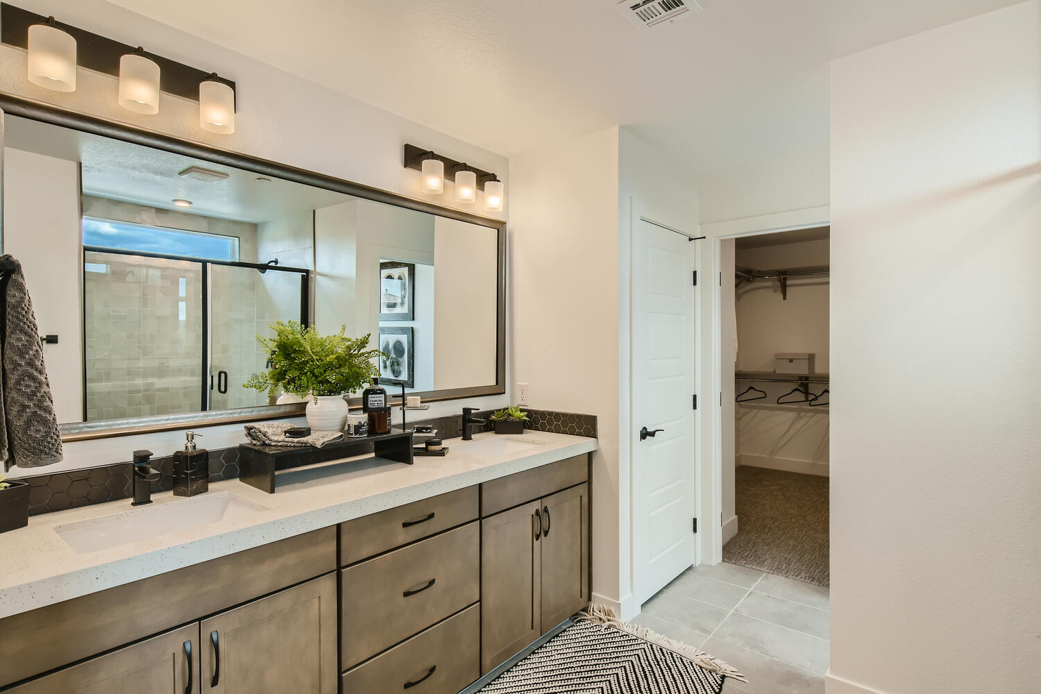 A bathroom with a large mirror.