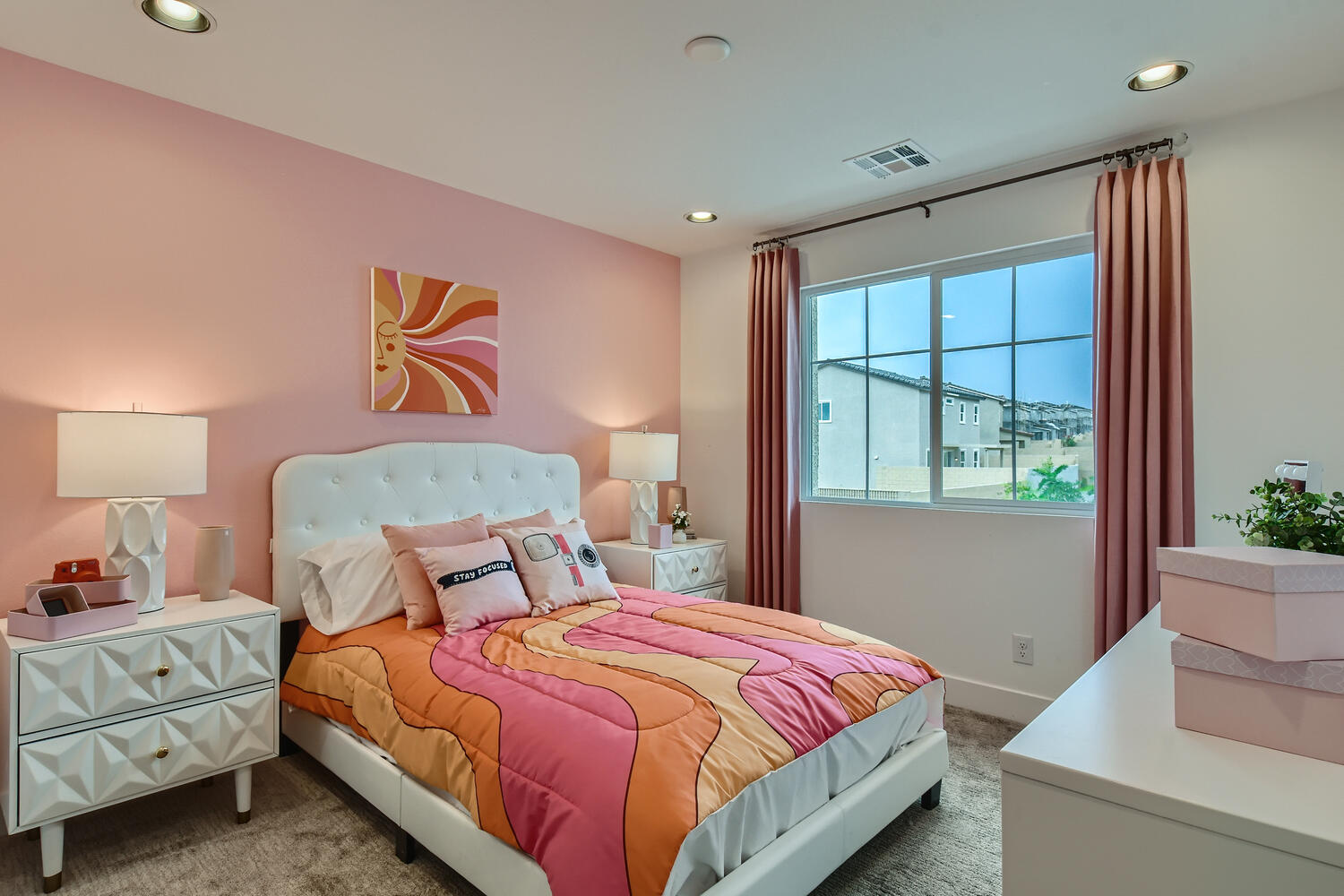 A bedroom with a large window.