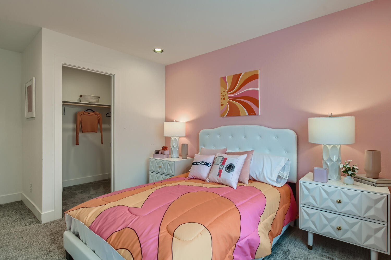 A bedroom with pink walls.