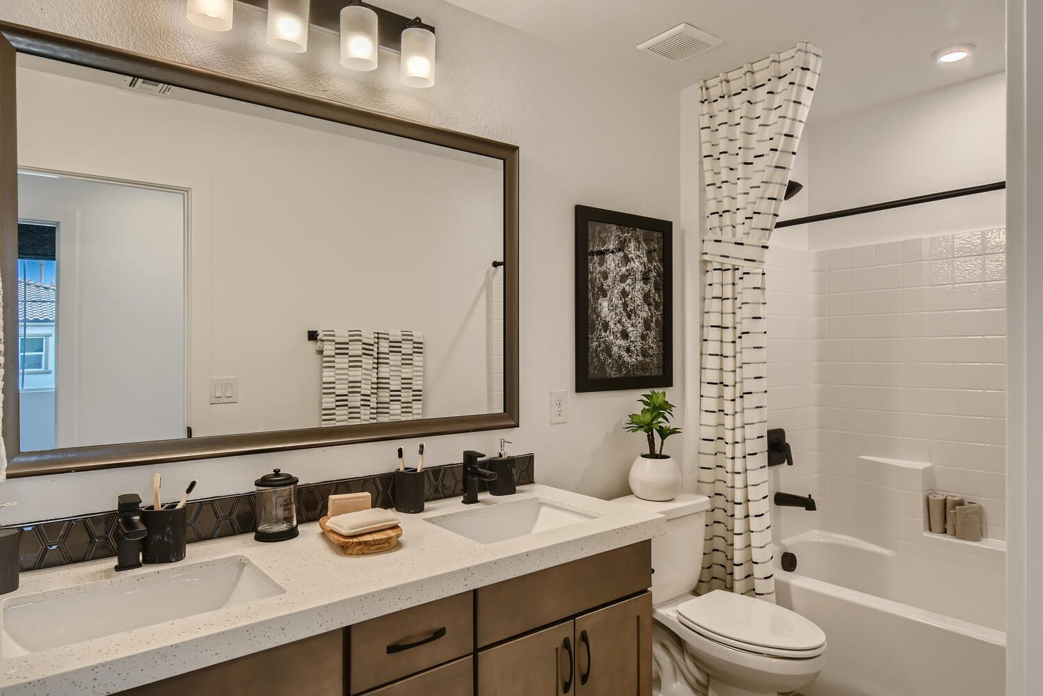 A bathroom with a large mirror.