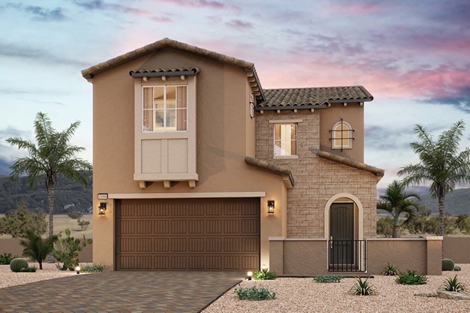 A house with a garage and palm trees.