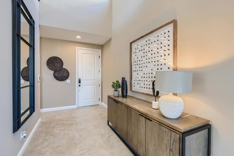 A room with a table and a lamp.