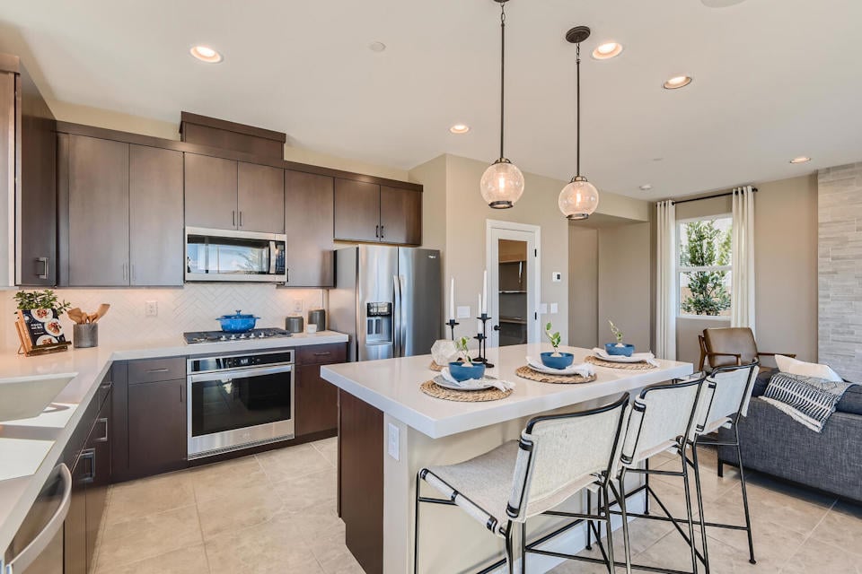 A kitchen with a dining table and a couch.