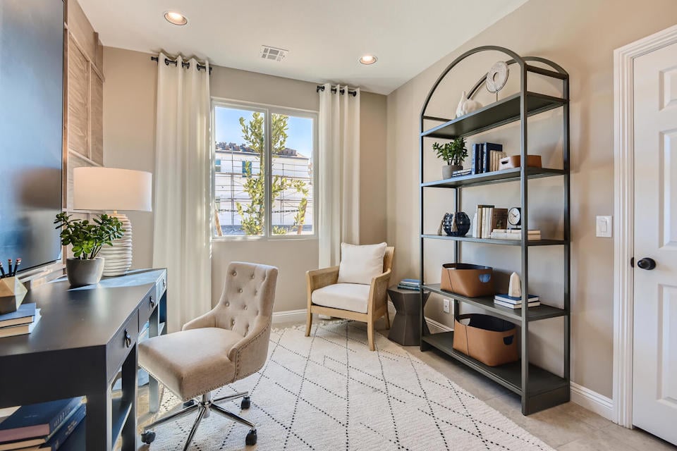 A room with a desk and chairs.