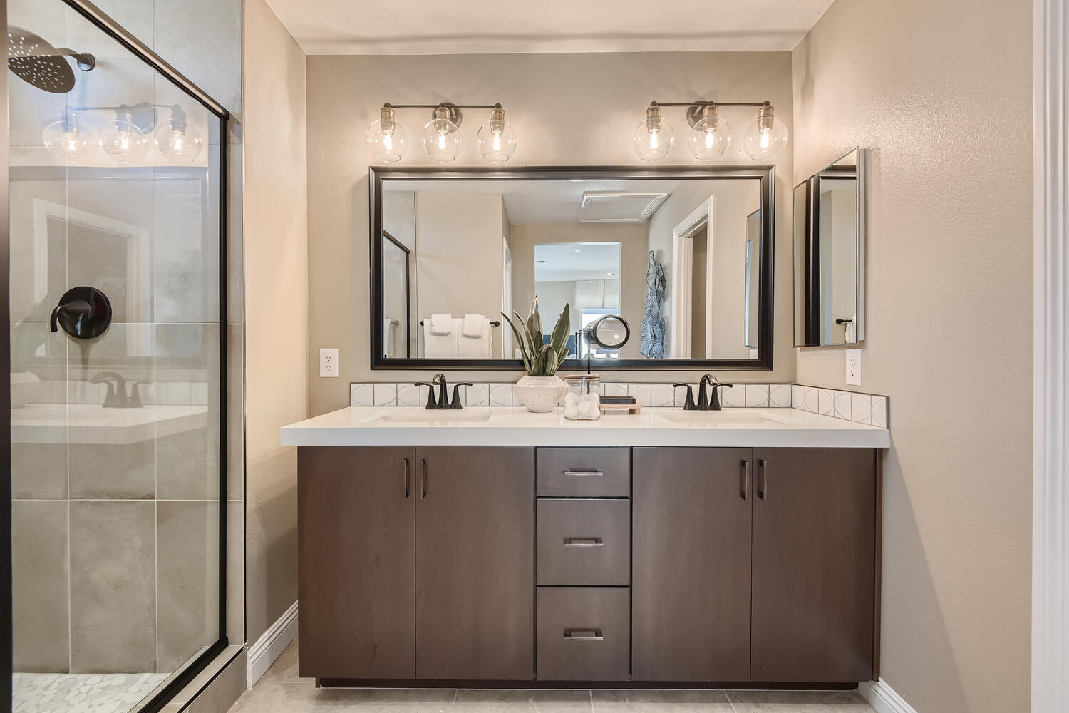 A bathroom with a large mirror.