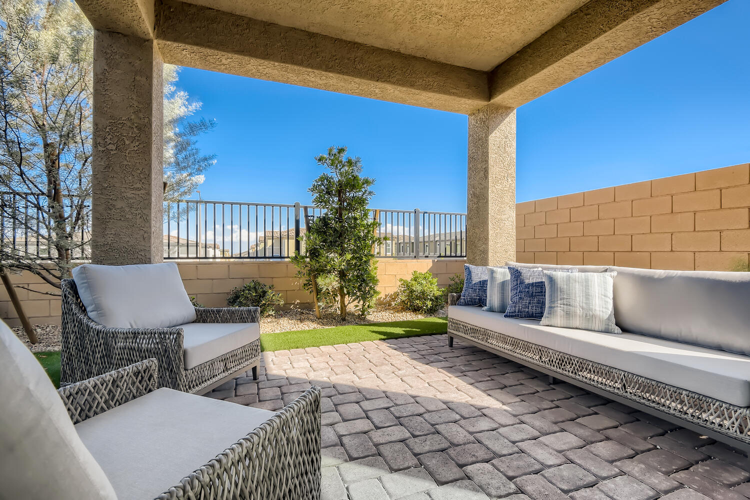A patio with a couch and a table and chairs.