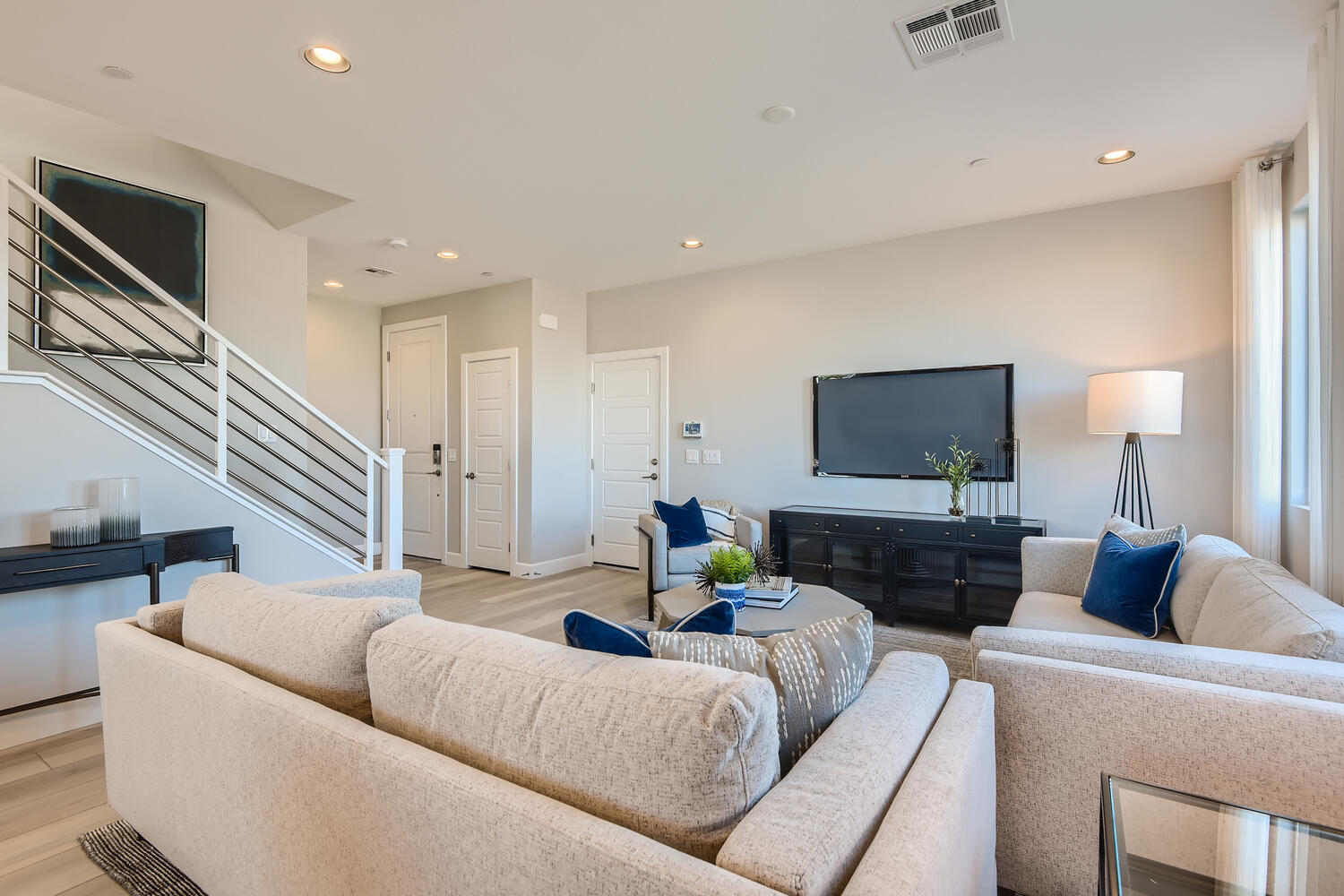 A living room with a tv and couches.