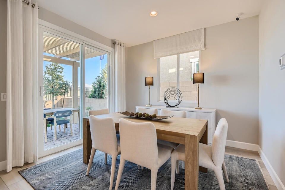 A dining room with a large window.
