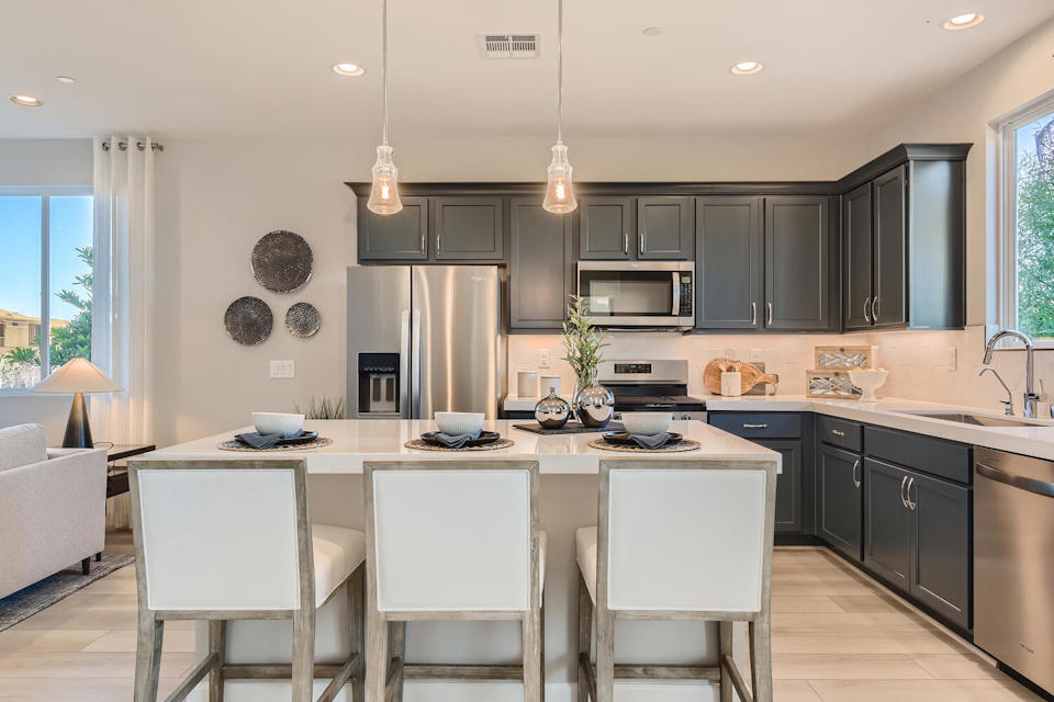 A kitchen with black cabinets.