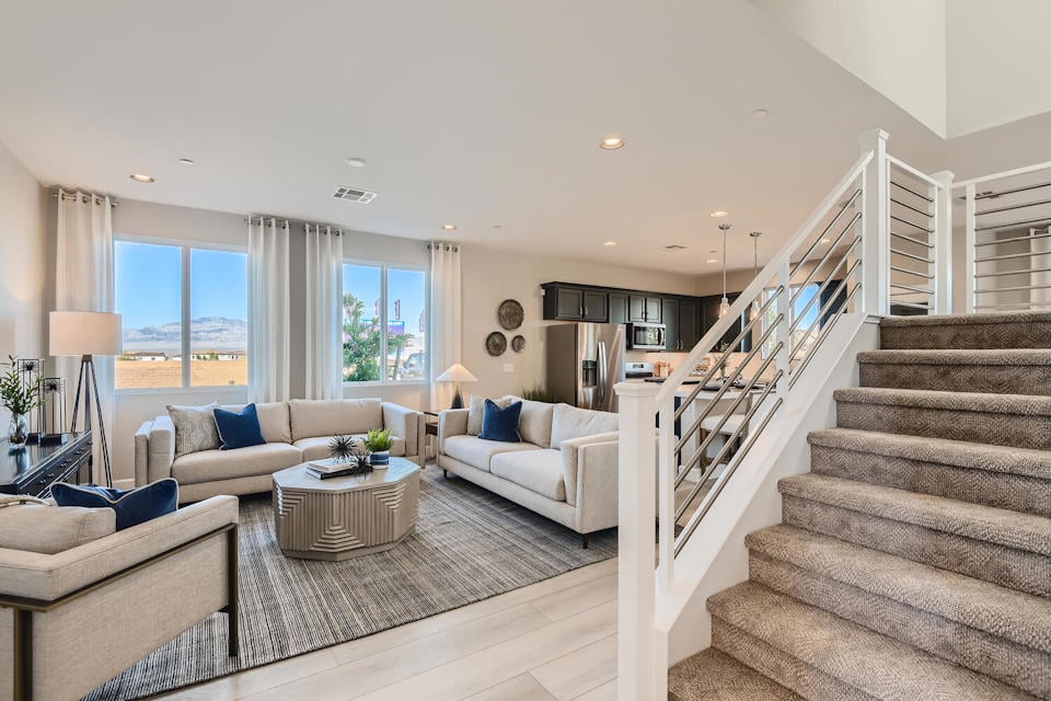 A living room with a staircase.