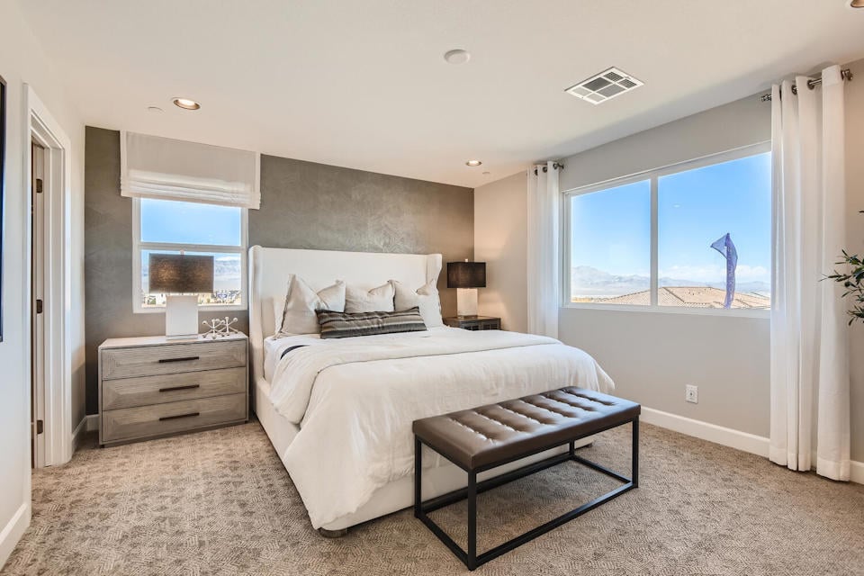 A bedroom with a large window.