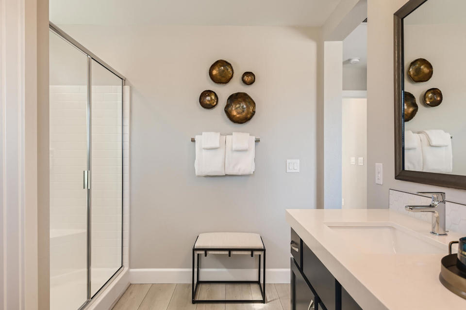 A bathroom with a sink and a mirror.