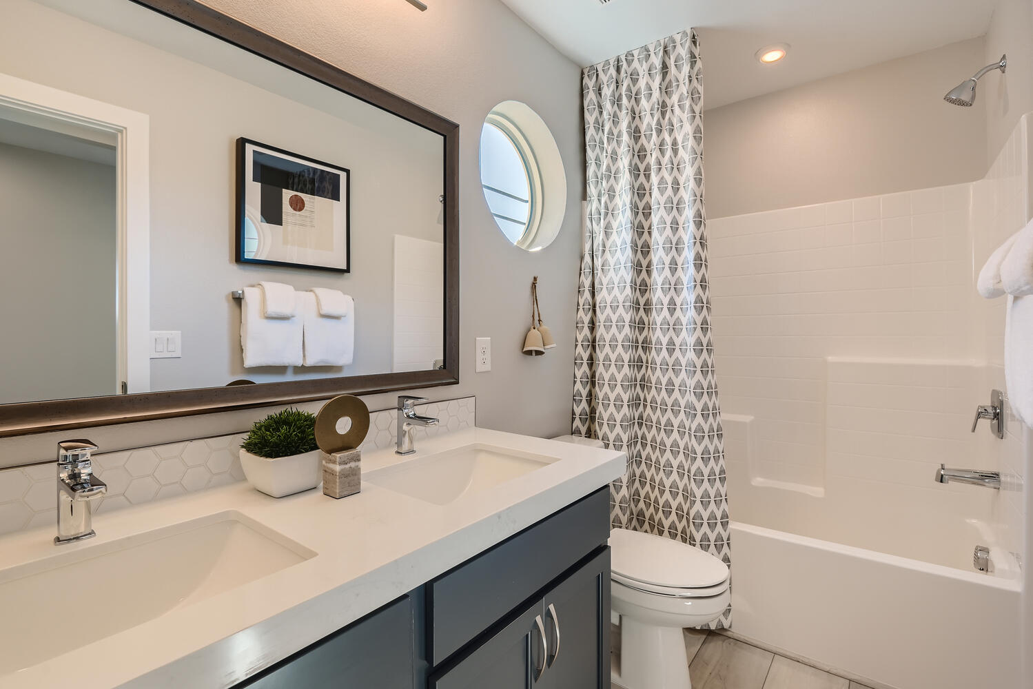 A bathroom with a tub sink and toilet.