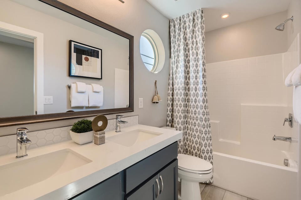 A bathroom with a tub sink and toilet.