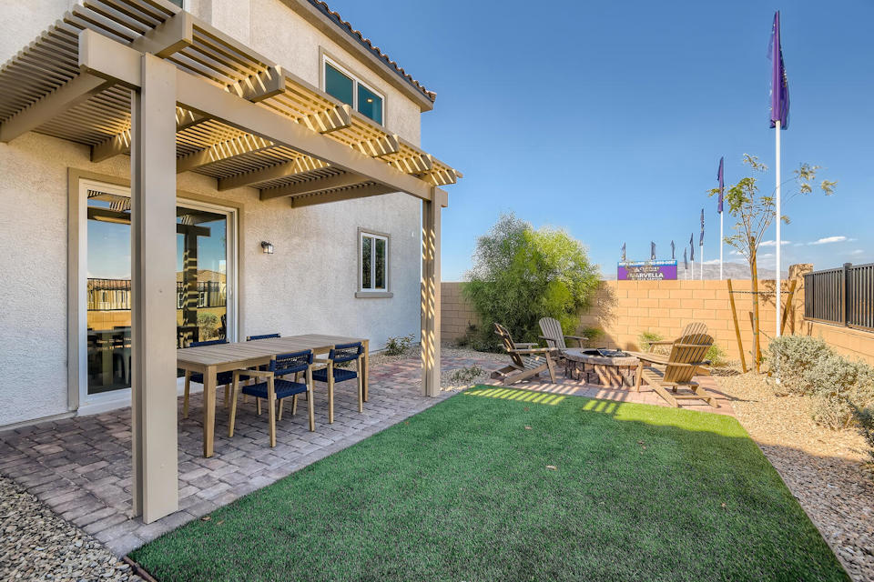 A house with a pool and a table and chairs.