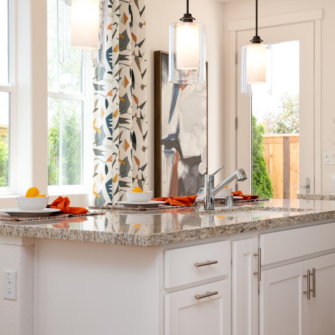 Colorful kitchen featuring center island and sink faucet.