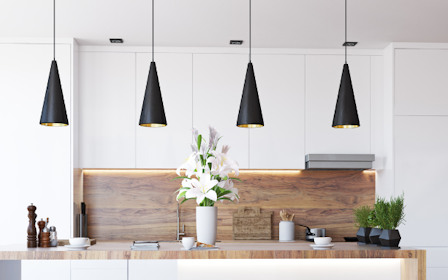 A kitchen with a table and shelves.
