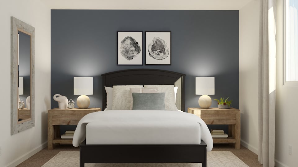 A bedroom with a bed and a table.