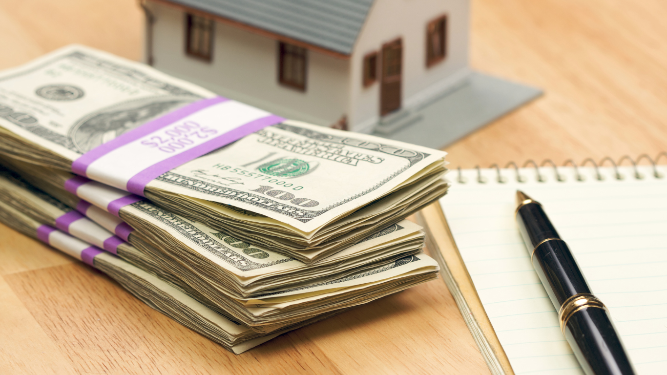 House and money with pad and pen
