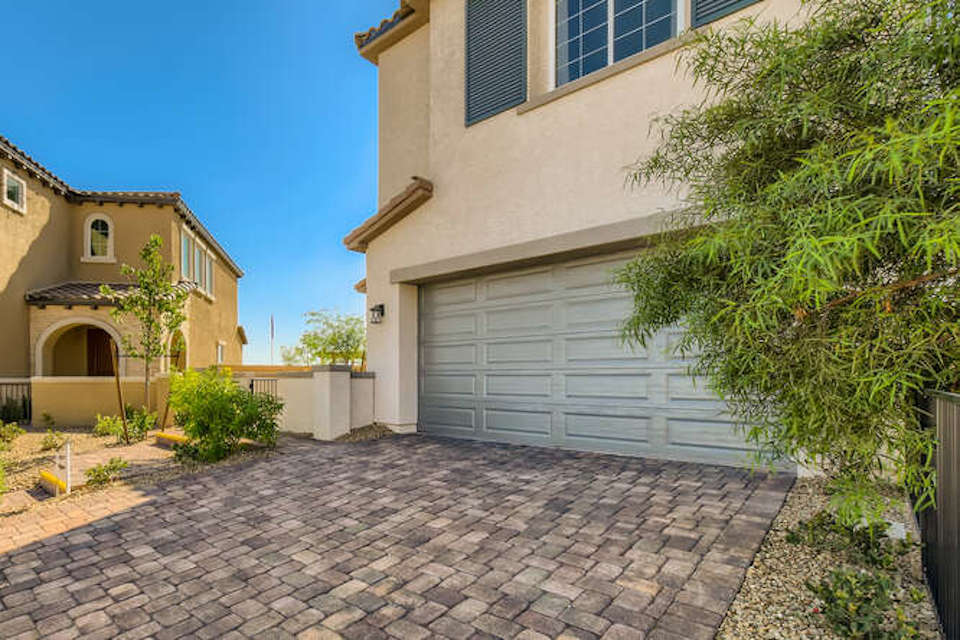 A brick driveway next to a building.