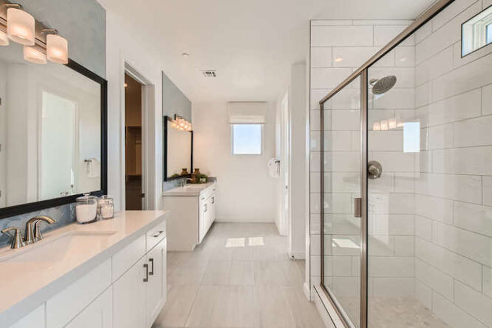 A bathroom with a shower unit and sink.