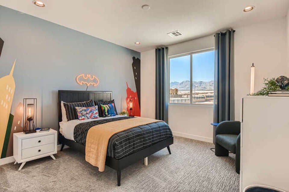 A bedroom with a large window.