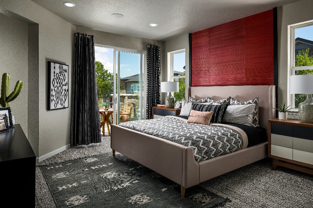 Bedroom with red accent wall behind bed