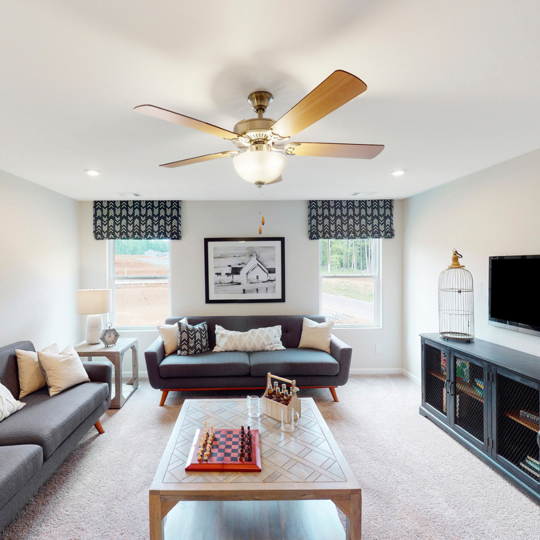 Flexible loft area with seating, game table and ceiling fan.