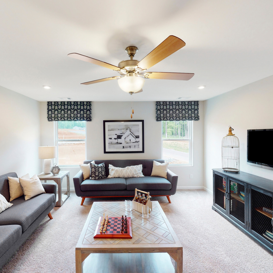 Flexible loft area with seating, game table and ceiling fan. 