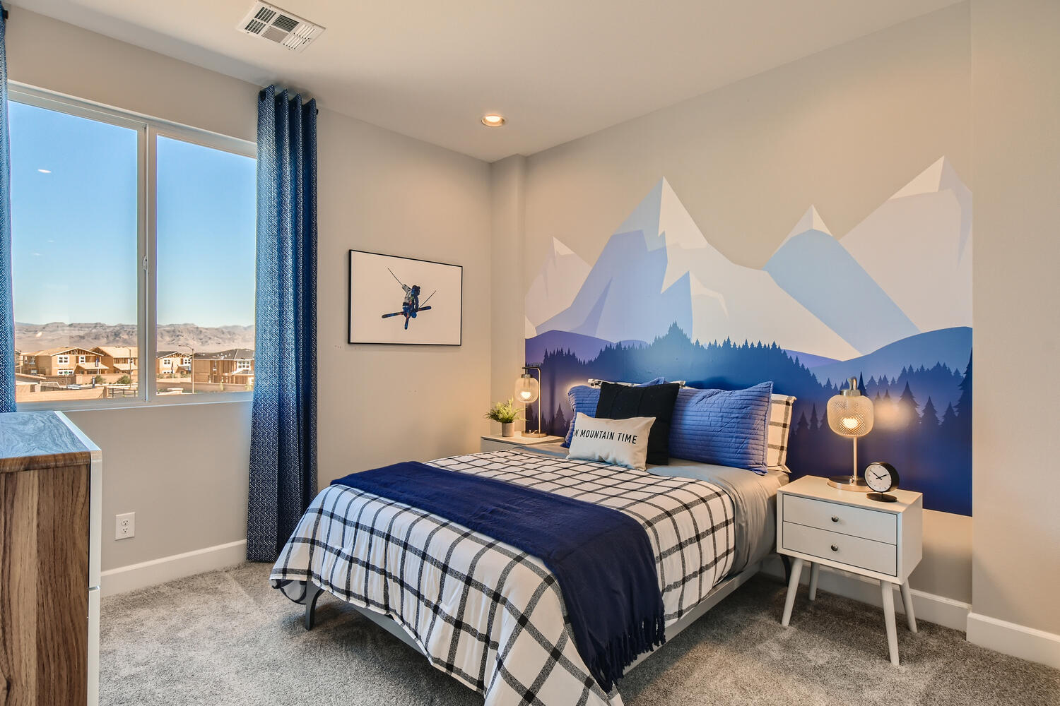 A bedroom with a blue bed.