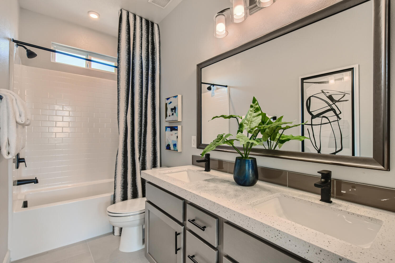 A bathroom with a large mirror.