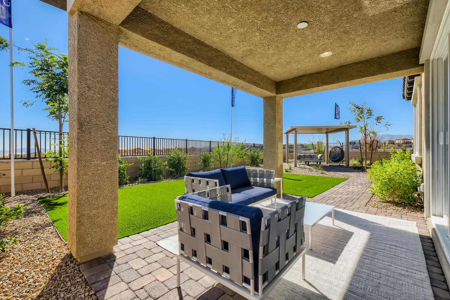 A deck with a couch and a pool.