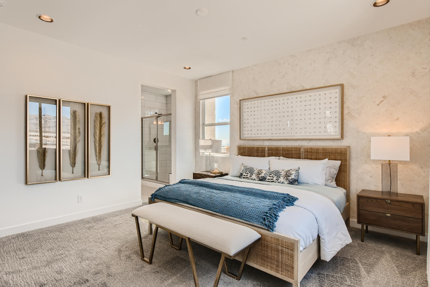 A bedroom with a bed and a bench.