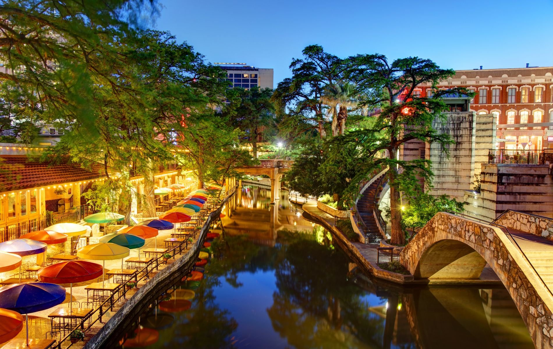 Nighttime photo of the River Walk in downtown San Antonio, TX