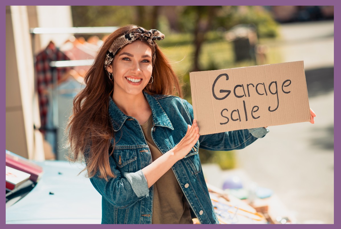 Host of the garage sale holding a sign