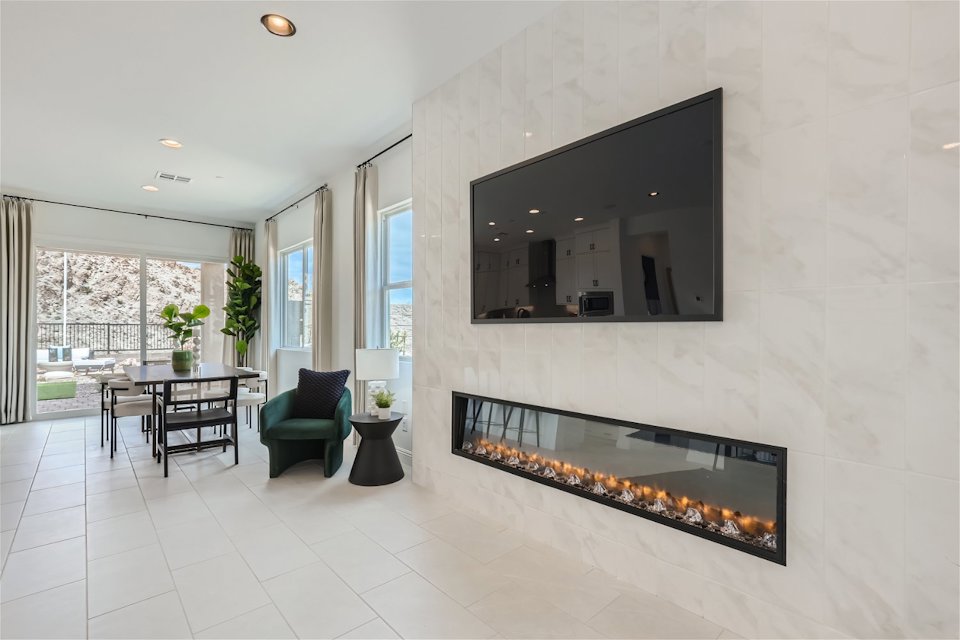 A room with a fireplace and a table.