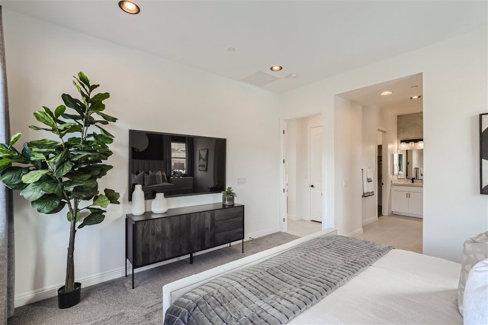 A bedroom with a bed and a tv.