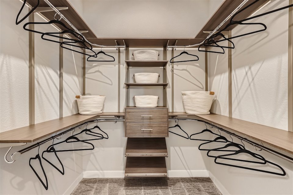 A room with a shelf and a table with a basket and a basket.