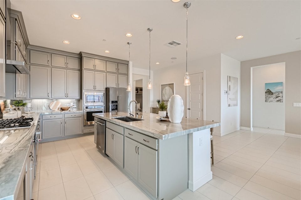 A kitchen with white cabinets.